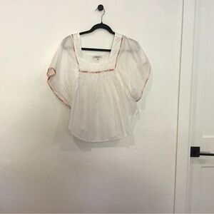 White blouse with pink and yellow thread ball detail